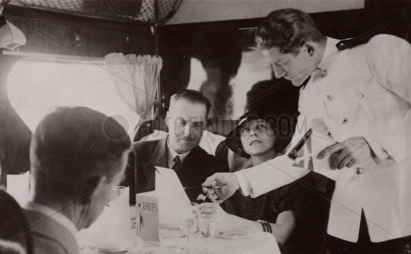 Steward serving lunch in the cabin of an Imperial Airways Scylla,  1934.
