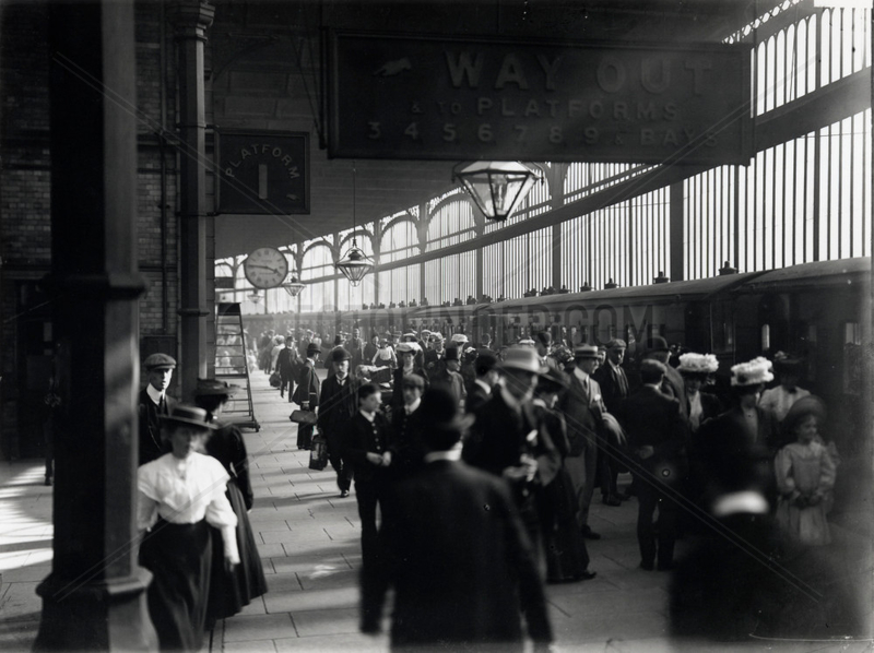 Railway travellers on a platform,  c 1900s.