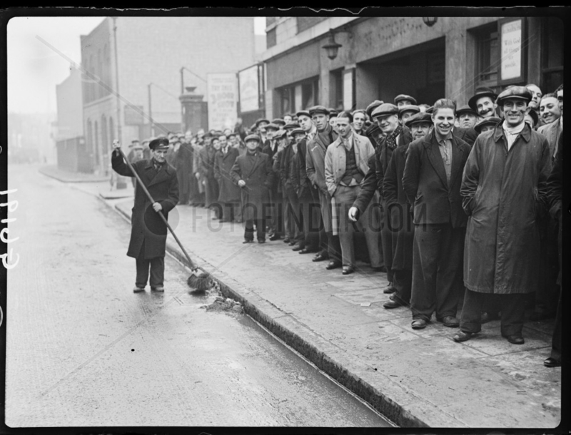 Queue of unemployed men,  Stepney,  London,  1938.