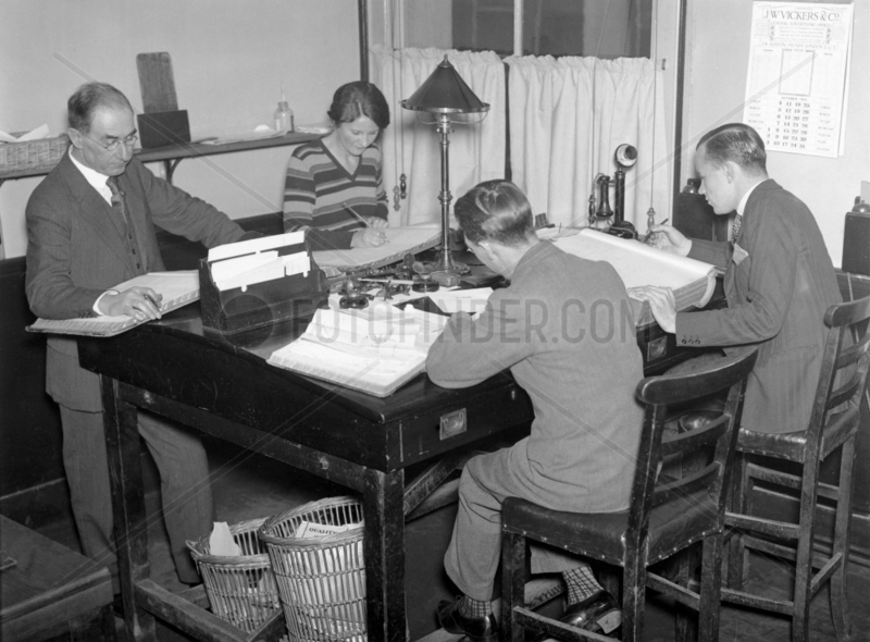 Four clerks at work in an office,  October 1