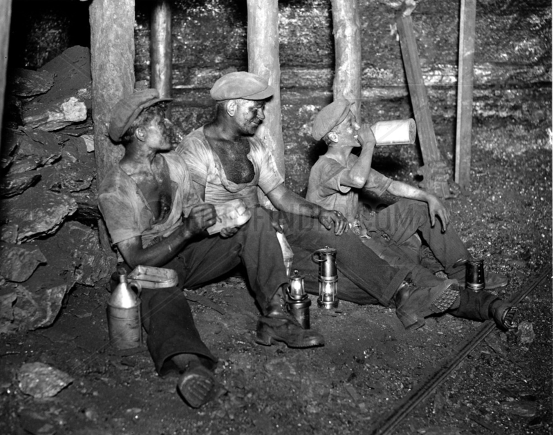 Coal miners taking their twenty minute rest,  South Wales,  24 June 1931.