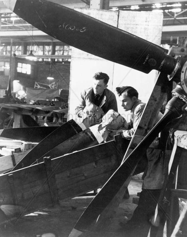 Men packing aeroplane propellers,  February