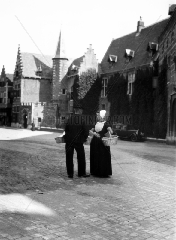 Dutch couple in conversation,  c 1910s.