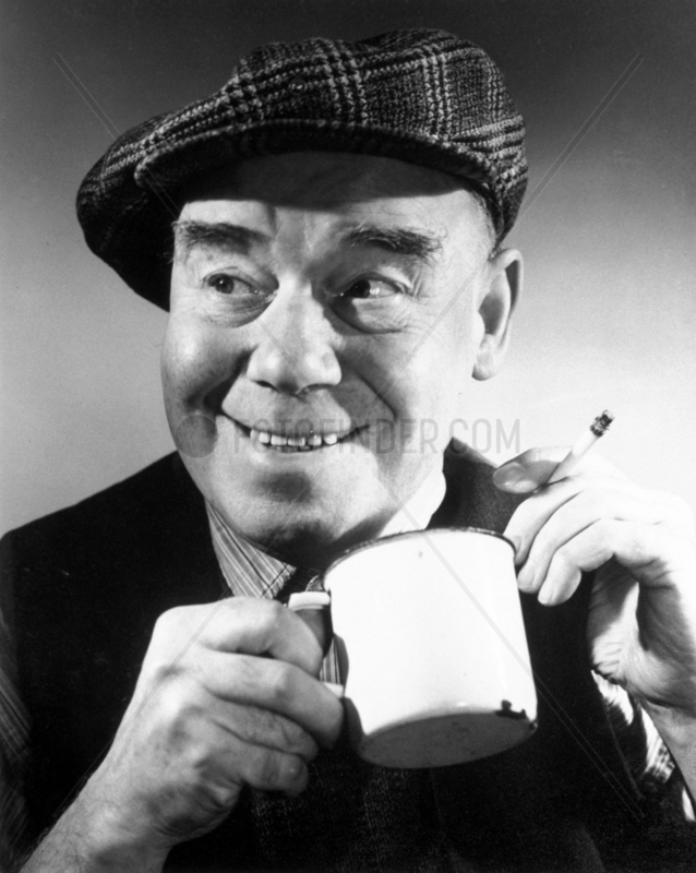 Man having a cup of tea and a cigarette,  c 1940s.