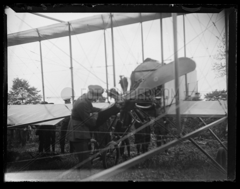 'Pilot Inspecting Aeroplane Propeller',  c 1910.
