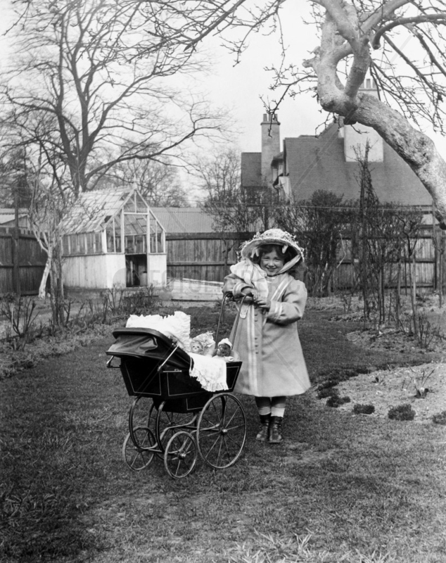 Girl with a pram full of dolls,  c 1910s.