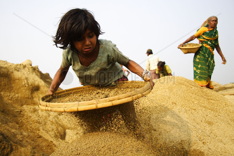 A girl sifting sand