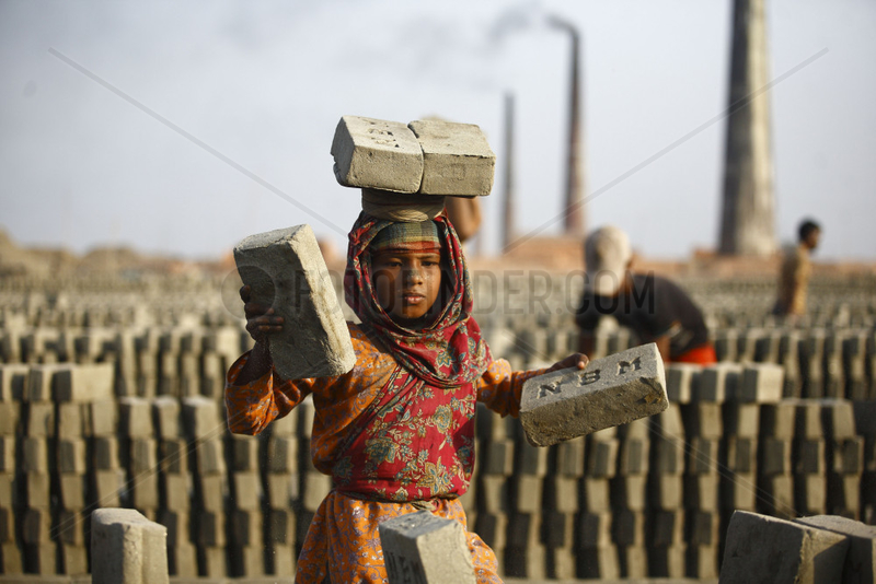 Girl child worker carrying bricks