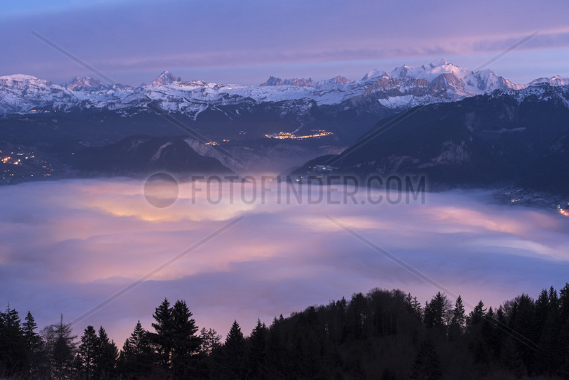 Stratus lit by Cluses in the setting sun and massif of Mont Blanc,  Alpes,  France