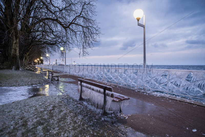 Bench and balustrade frozen in Evian,  on the front of Lake Geneva,  France