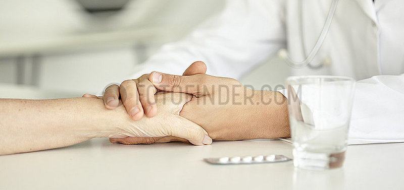Close-up of doctor holding patient's hand