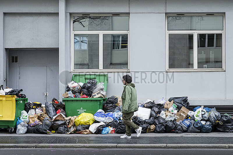 France. Paris (75) (14th district). At the beginning of March 2023,  trash cans and rubbish pile up on the sidewalks,  following a garbage collectors' strike,  in protest against the government's pension reform project (here,  Sante street)