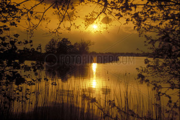 Sonnenuntergang ueber Seenlandschaft