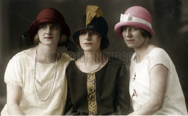 Drei Frauen mit modischen Huetten