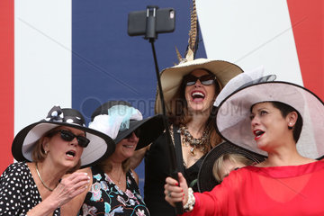 Royal Ascot  Fashion  women with hats takes a Selfie with a Selfie-stick
