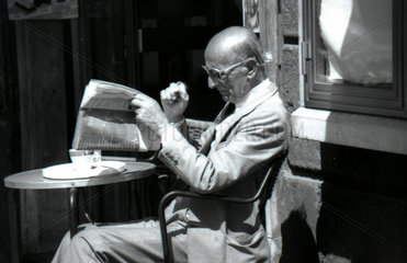 Aeltere Mann beim Zeitungslesen