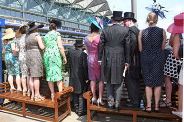 Royal Ascot  Audience at the parade ring standing on benches and waiting for the Queen