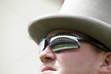 Royal Ascot  the grandstand mirrores in the sunglasses of a man