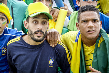 Brazilian football supporters watching match in anticipation