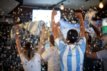 Argentinian football fans watching football match at sports bar