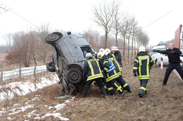 Heiligenstedten  Deutschland  Feuerwehrmaenner bei Bergungsarbeiten nach einem Verkehrsunfall