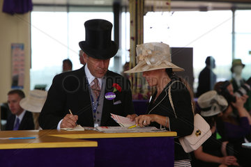 Royal Ascot  Fashion  woman with hat and man with top hat at the racecourse