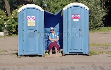 Putzfrau zwischen zwei mobilen Toiletten  Kaliningrad  Russland