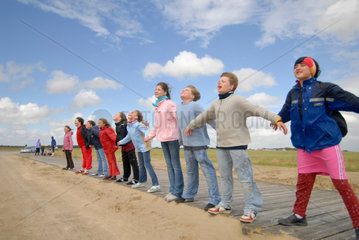 St. Peter-Ording  Deutschland  Kinder stellen sich an der Nordsee in den Wind