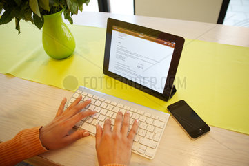 Hamburg  Deutschland  Frau arbeitet mit ihrem iPad 2 in einem Cafe