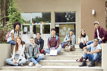 College students sitting outdoors on campus  portrait