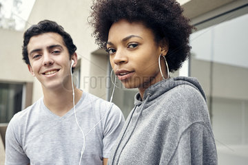 Friends listening to music together with earphones  portrait