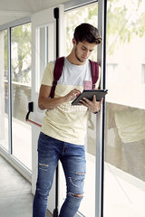 College student looking at digital tablet between classes