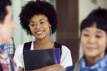 Female college student smiling in corridor