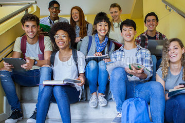 Group of college students studying on stairs  portrait