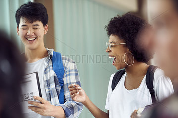 Students laughing together in corridor