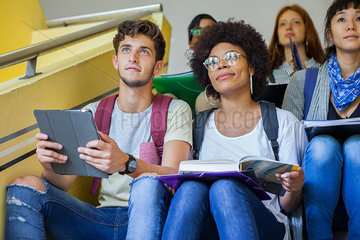 Group of college students studying on stairs