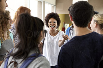 Students chatting together in school corridor