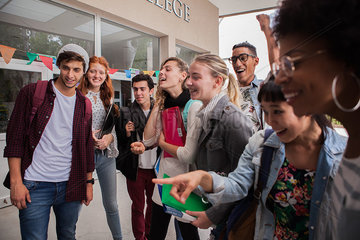 College students gathered together on campus  looking excited