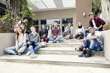 College students sitting on steps outside building  portrait