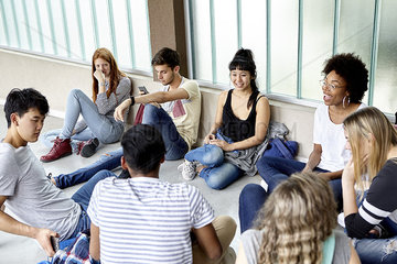 Group of students hanging out together in corridor