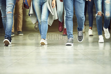 High school students walking in corridor  low section