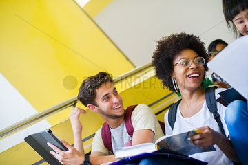 College students laughing while studying between classes