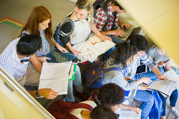 Group of students studying together in stairwell