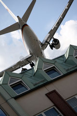 Berlin  Deutschland  ein tief fliegendes Flugzeug fliegt ueber ein Wohngebaeude