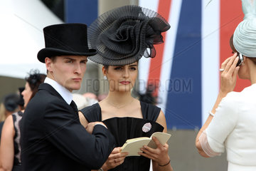 Royal Ascot  Fashion  woman with hat and man with top hat at the racecourse