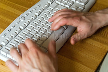 Berlin  Deutschland  ein Mann schreibt an einem Computer