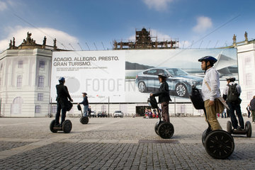 Berlin  Deutschland  Elektroroller Segway vor einem Grossplakat von BMW