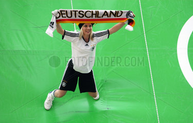 Muenchen  Deutschland  Frau zeigt einen Schal mit der Aufschrift Deutschland