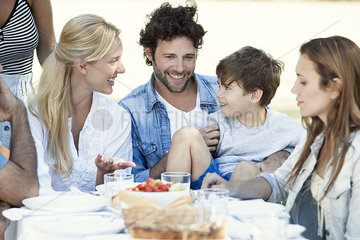 Family eating meal together outdoors