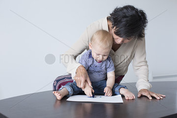 Grandmother drawing with baby